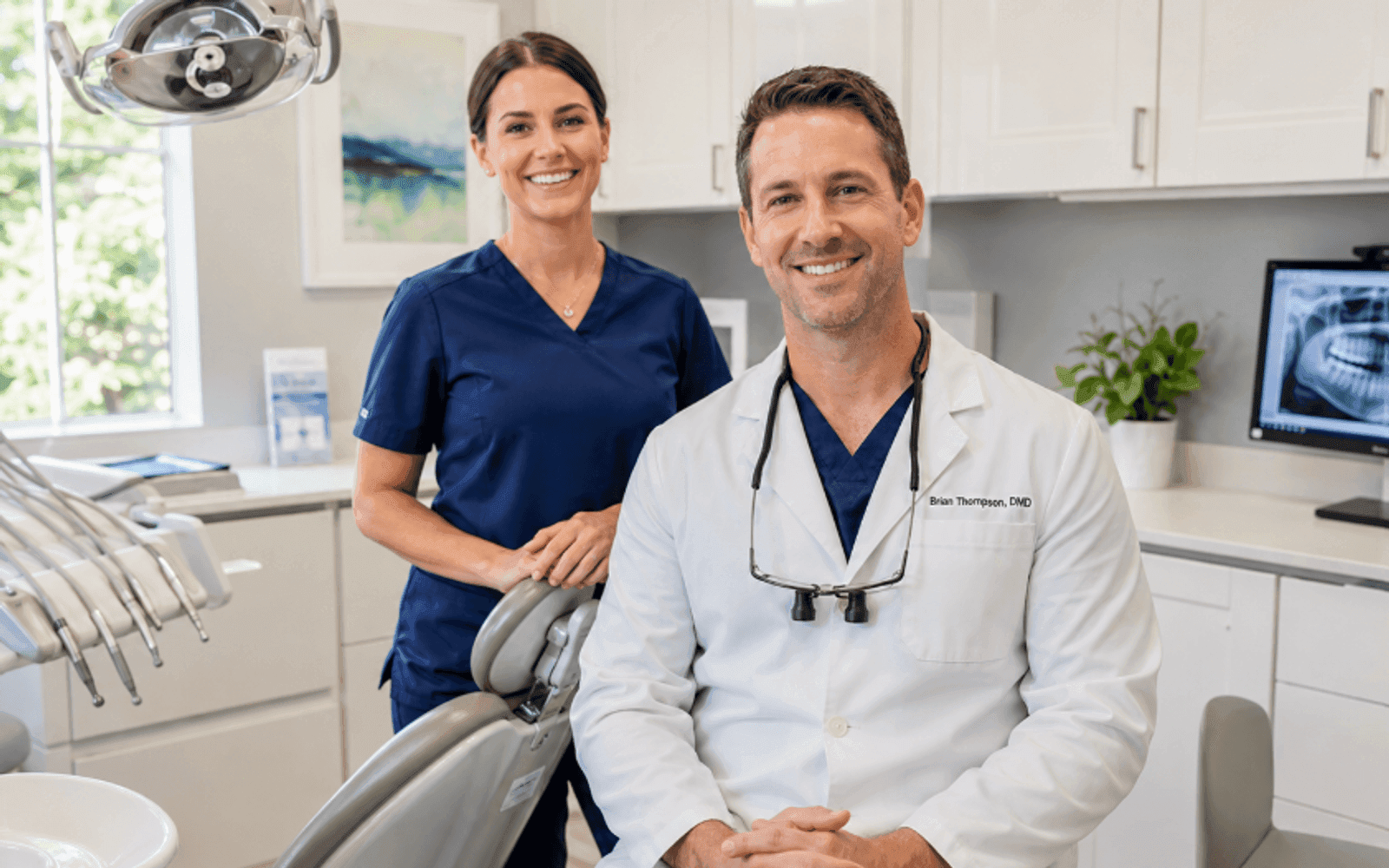 Dentist and assistant in a bright, modern US dental treatment room